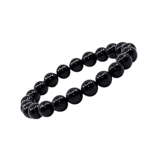 Pulseira de Turmalina Negra natural com esferas de 8 mm, tradicionalmente associada à proteção energética, estabilidade e ancoramento.